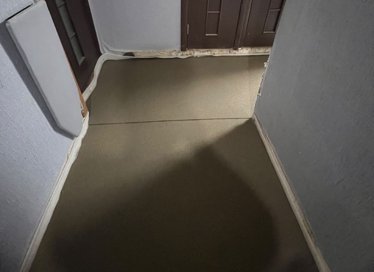 Полусухая стяжка в прихожей квартиры 28 м² в Железнодорожном (Балашиха) — ровная поверхность у входной двери
